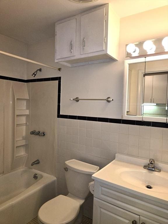 6 Venice St Unit F2, Danvers, MA 01923 - bathroom with tile walls, toilet, vanity, and shower / washtub combination
