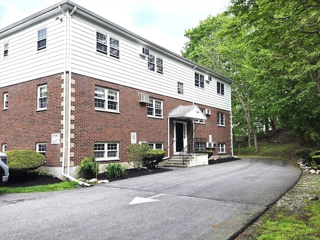 6 Venice St Unit F2, Danvers, MA 01923 - view of front facade with a wall mounted AC and brick siding