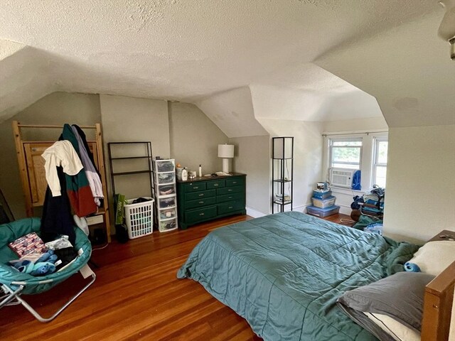 98 Everett St Unit 98, Easthampton, MA 01027 - bedroom with wood finished floors, a textured ceiling, lofted ceiling, and cooling unit