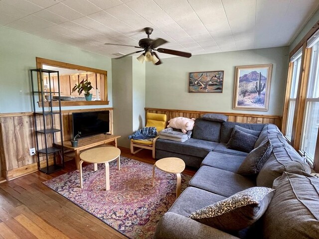 98 Everett St Unit 98, Easthampton, MA 01027 - living area featuring hardwood / wood-style floors, a wainscoted wall, a ceiling fan, and wooden walls
