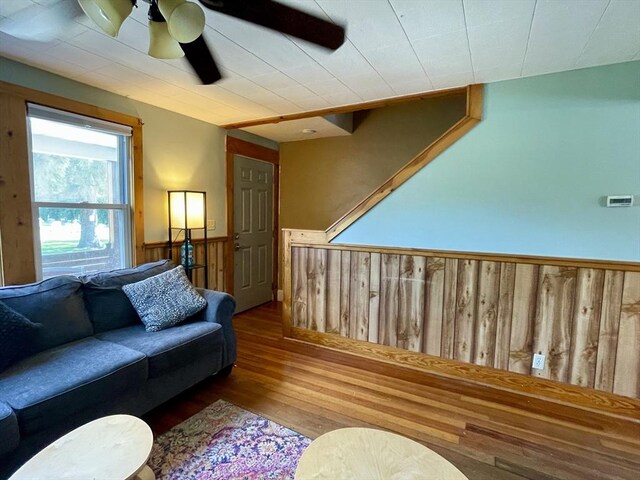 98 Everett St Unit 98, Easthampton, MA 01027 - living area featuring a wainscoted wall, wood finished floors, ceiling fan, and wood walls