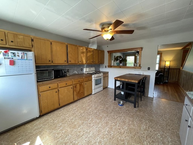 98 Everett St Unit 98, Easthampton, MA 01027 - kitchen featuring white appliances, ceiling fan, tasteful backsplash, and brown cabinets
