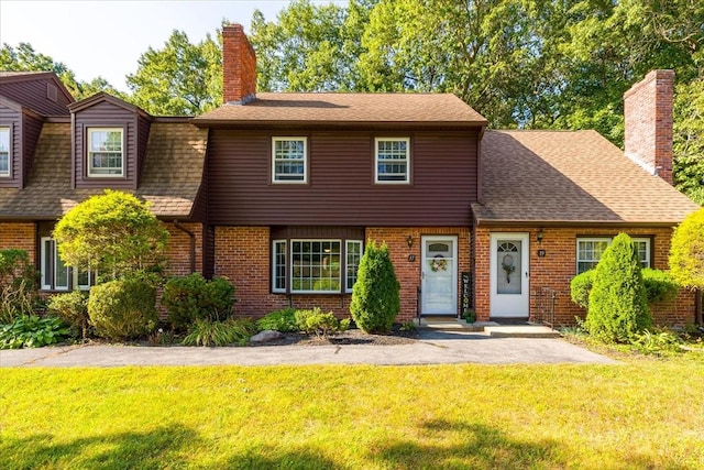 17 York Towne Ter Unit 17, Holden, MA 01520 - view of front of home featuring a front lawn, a chimney, and brick siding