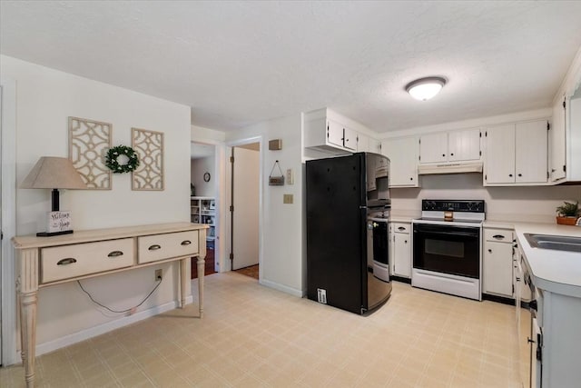 17 York Towne Ter Unit 17, Holden, MA 01520 - kitchen with range with electric stovetop, freestanding refrigerator, under cabinet range hood, light countertops, and light floors