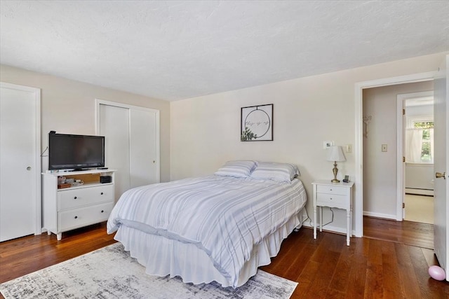 17 York Towne Ter Unit 17, Holden, MA 01520 - bedroom featuring a baseboard radiator, wood finished floors, and baseboards