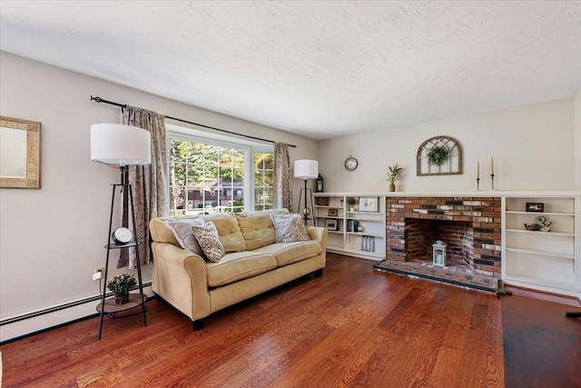 17 York Towne Ter Unit 17, Holden, MA 01520 - living area with wood finished floors, a textured ceiling, a brick fireplace, and baseboard heating