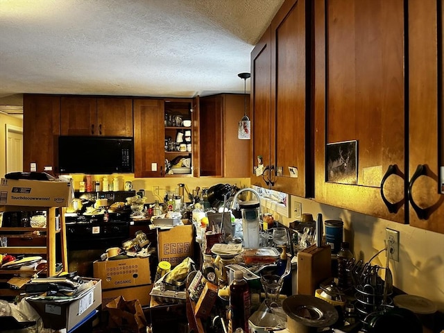 kitchen featuring open shelves, brown cabinetry, black microwave, and a textured ceiling