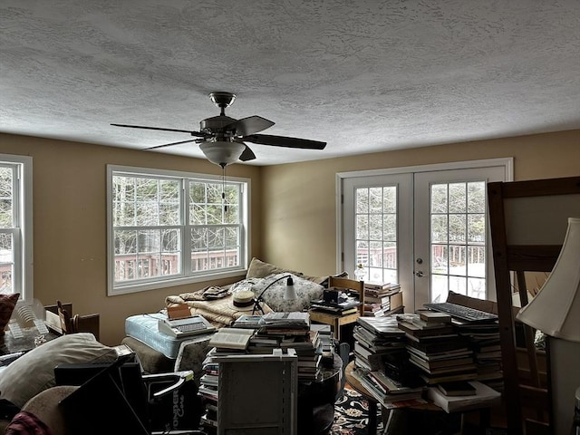 miscellaneous room featuring a wealth of natural light, french doors, a textured ceiling, and ceiling fan