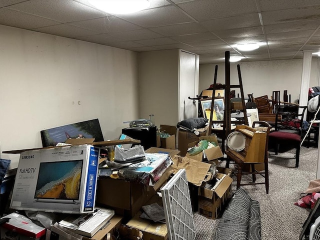 miscellaneous room with a drop ceiling and carpet