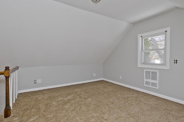bonus room with baseboards, carpet flooring, vaulted ceiling, and visible vents