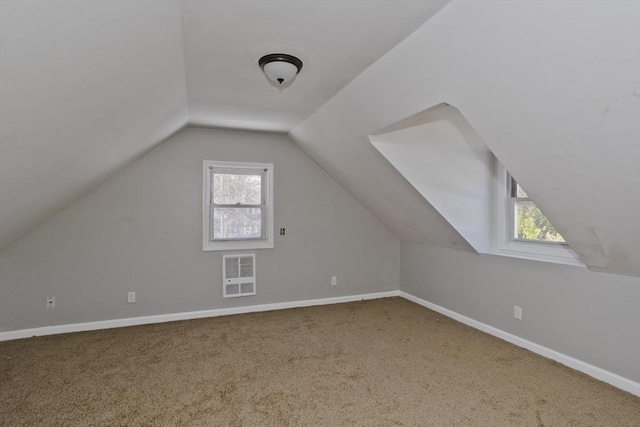 bonus room with carpet floors, baseboards, vaulted ceiling, and plenty of natural light