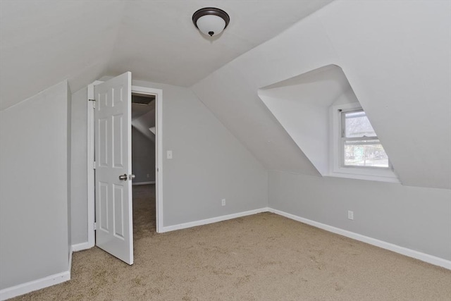 bonus room with carpet floors, baseboards, and vaulted ceiling