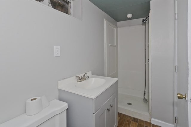 full bathroom with toilet, a shower stall, wood finished floors, and vanity