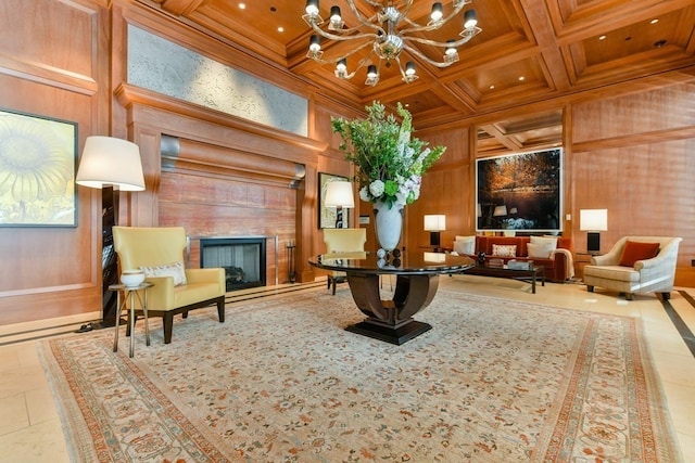 living area with wood walls, a chandelier, coffered ceiling, beamed ceiling, and light tile patterned floors