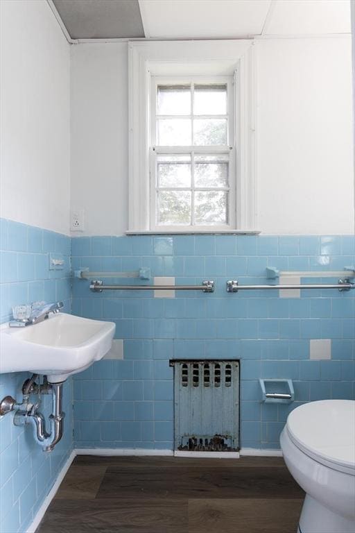10 Ravenna Rd, Boston, MA 02132 - half bathroom with radiator heating unit, tile walls, wood finished floors, and wainscoting