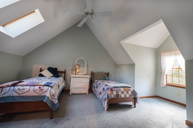 carpeted bedroom with ceiling fan and lofted ceiling with skylight