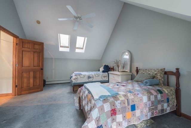 bedroom with a baseboard heating unit, vaulted ceiling with skylight, multiple windows, carpet flooring, and ceiling fan