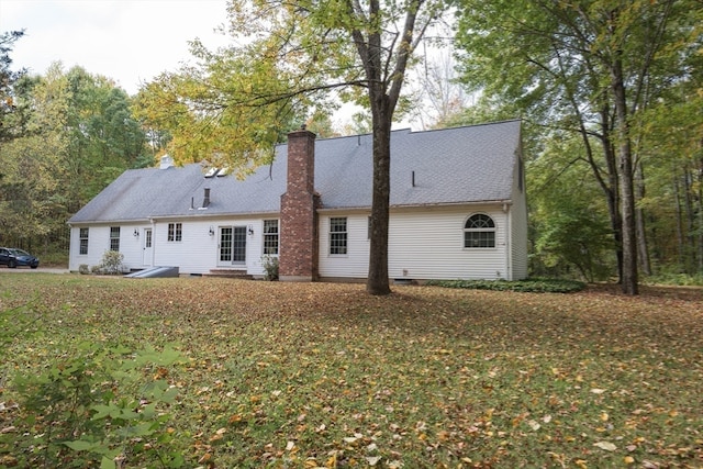 back of property featuring a lawn