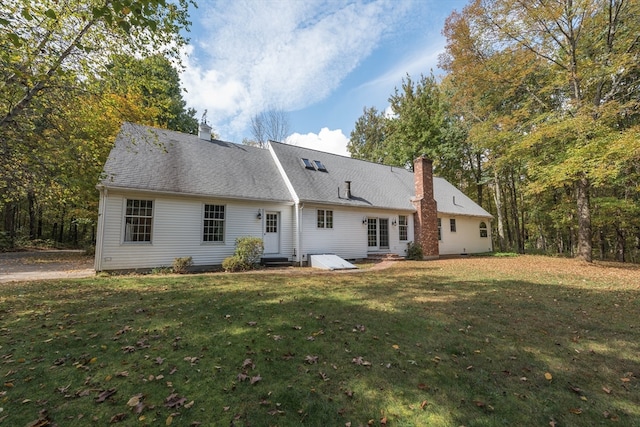 rear view of property featuring a yard