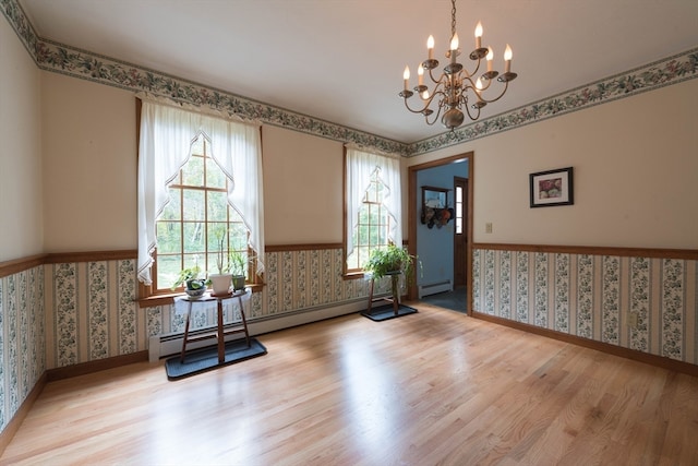 interior space with light hardwood / wood-style floors, an inviting chandelier, and a baseboard radiator