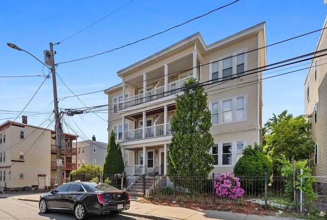 14 Estella St Unit 2, Boston, MA 02126 - view of front of home with a balcony and a fenced front yard
