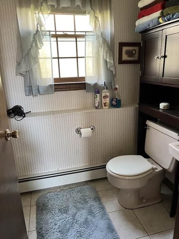 bathroom featuring tile patterned floors, a baseboard heating unit, and toilet