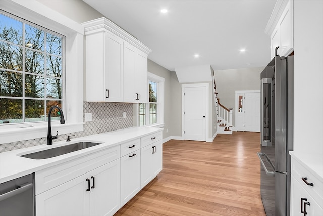 kitchen with stainless steel appliances, plenty of natural light, and sink