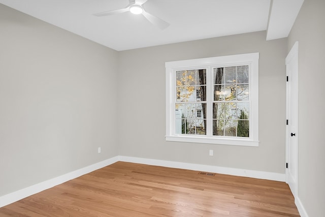 empty room with light wood-type flooring and ceiling fan