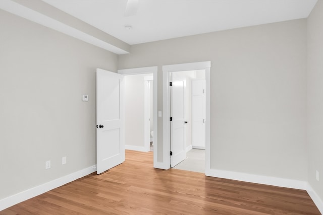 unfurnished bedroom with ceiling fan and light hardwood / wood-style floors