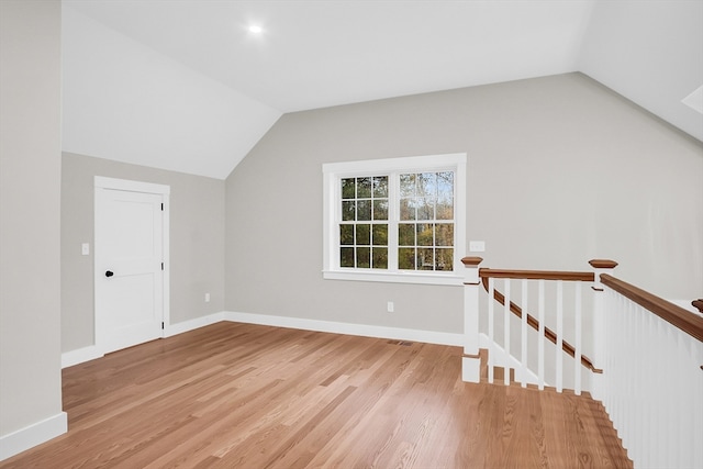 bonus room with light hardwood / wood-style floors and lofted ceiling