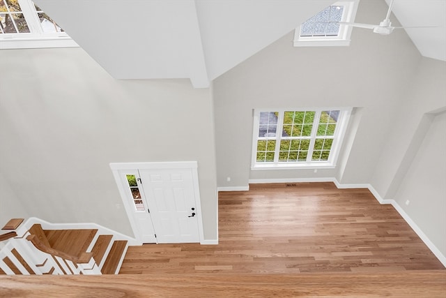 unfurnished living room featuring hardwood / wood-style flooring and high vaulted ceiling