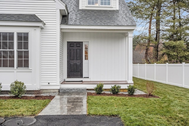 doorway to property featuring a lawn