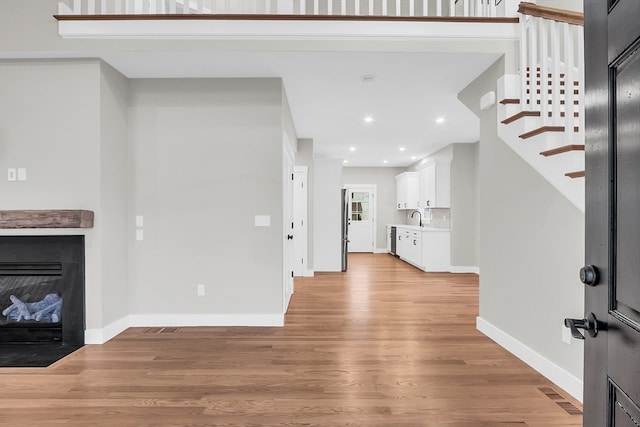 living room featuring light hardwood / wood-style flooring and sink