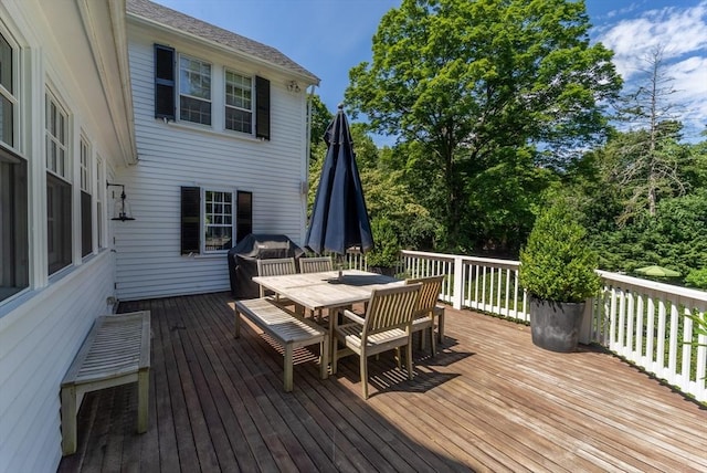 deck featuring outdoor dining area and area for grilling