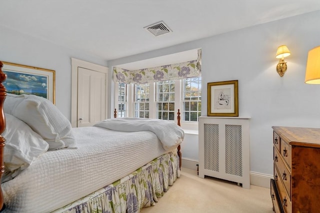 bedroom featuring visible vents, light colored carpet, baseboards, and radiator