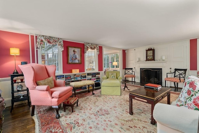 living room with a fireplace and wood finished floors