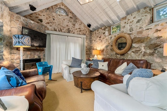living room featuring high vaulted ceiling, a fireplace, carpet, and a healthy amount of sunlight