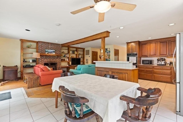 90 Southern Ave Unit 90, Essex, MA 01929 - dining area with light tile patterned flooring, ceiling fan, recessed lighting, and a brick fireplace