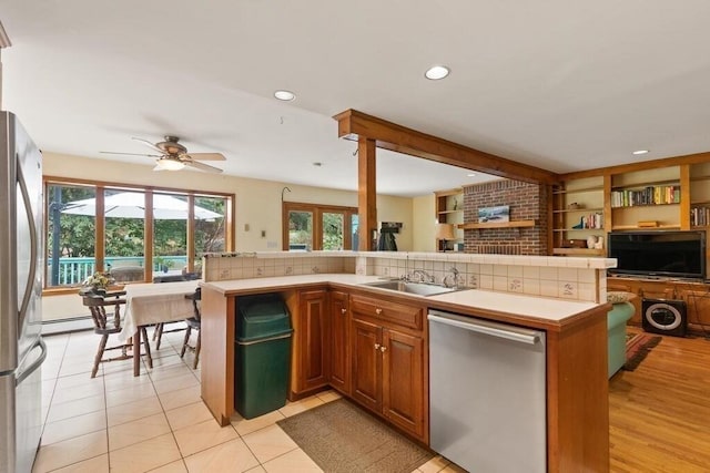 90 Southern Ave Unit 90, Essex, MA 01929 - kitchen with appliances with stainless steel finishes, a sink, open floor plan, a ceiling fan, and light countertops