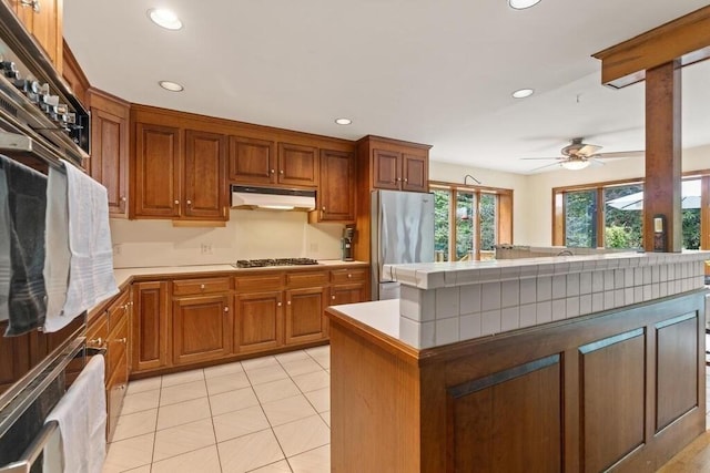 90 Southern Ave Unit 90, Essex, MA 01929 - kitchen featuring stainless steel appliances, under cabinet range hood, ceiling fan, recessed lighting, and brown cabinetry