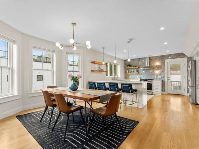 39 Paul St, Watertown, MA 02472 - dining area featuring a chandelier, light wood-style flooring, and baseboards