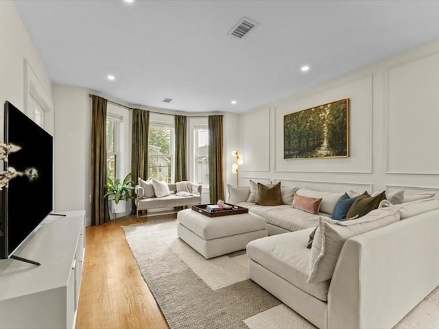 39 Paul St, Watertown, MA 02472 - living room with a decorative wall, light wood finished floors, and recessed lighting
