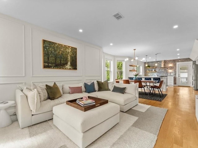 39 Paul St, Watertown, MA 02472 - living room with a decorative wall, light wood-style flooring, and recessed lighting