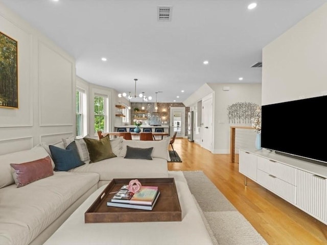 39 Paul St, Watertown, MA 02472 - living room with a chandelier, light wood-style floors, recessed lighting, and baseboards