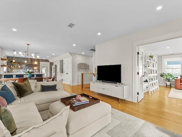 39 Paul St, Watertown, MA 02472 - living area featuring light wood finished floors, recessed lighting, and baseboards