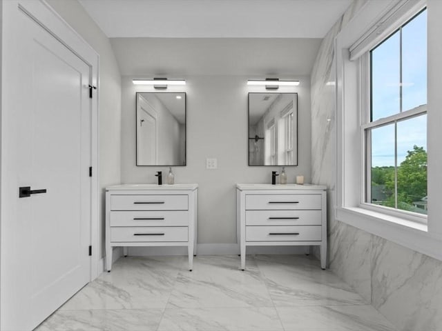 39 Paul St, Watertown, MA 02472 - bathroom with marble finish floors, two vanities, and baseboards