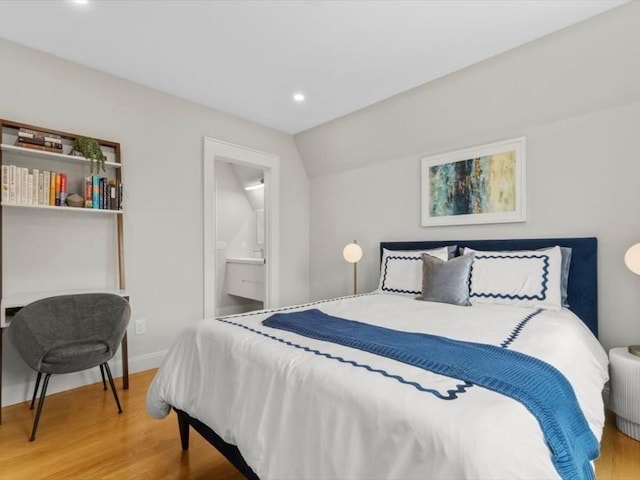 39 Paul St, Watertown, MA 02472 - bedroom with wood finished floors, recessed lighting, baseboards, lofted ceiling, and ensuite bathroom