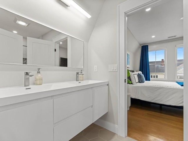 39 Paul St, Watertown, MA 02472 - bathroom featuring ensuite bath, double vanity, recessed lighting, lofted ceiling, and tile patterned floors
