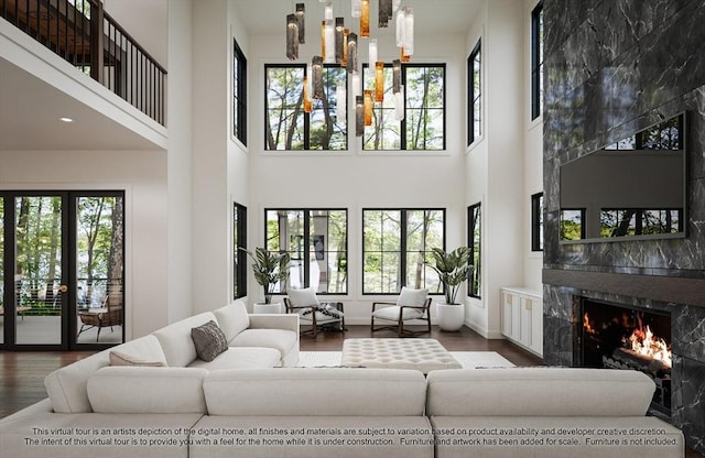 LOT3 Ridge Rd, Northborough, MA 01532 - living area featuring wood finished floors, a towering ceiling, a fireplace, and baseboards