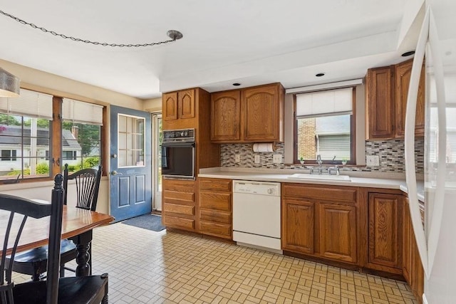 32 Cambo St, Brockton, MA 02301 - kitchen featuring white appliances, light countertops, brown cabinetry, decorative backsplash, and healthy amount of natural light